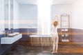 White and blue bathroom, wooden tub, woman Royalty Free Stock Photo