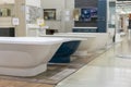 White and blue bathtubs in a hardware store. The concept of choosing and installing bathtubs Royalty Free Stock Photo