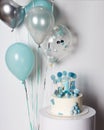 White and blue cake with candy and cookie