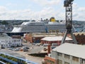 A white blue cruise ship lies in the harbor of Falmouth