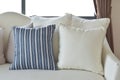 White and blue decorative pillows on a casual sofa in the living room