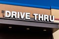 White and Blue Drive Thru sign set against a blue sky I Royalty Free Stock Photo