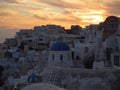 White and blue Greek Island Style architecture against golden evening sky at Oia village, Santorini Island Royalty Free Stock Photo