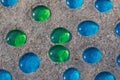 White, blue and green glass beads on sand Royalty Free Stock Photo