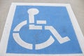 A white and blue handicap parking lot reservation spot