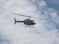 White and Blue Helicopter in the Clouds