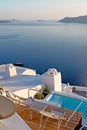 white and blue house in santorini pool