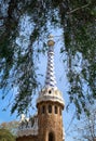 White and blue mosaic covered tower at the entrance of the Park GÃÂ¼ell