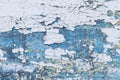 White and blue paint is peeling off on metal surface Royalty Free Stock Photo