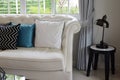 White and blue pillows on a white leather couch Royalty Free Stock Photo