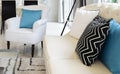 White and blue pillows on a white leather couch Royalty Free Stock Photo