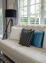 White and blue pillows on a white leather couch Royalty Free Stock Photo