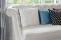 White and blue pillows on a white leather couch in vintage living room Royalty Free Stock Photo