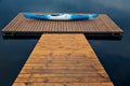 White-blue plastic kayak lying on a wooden dock