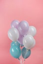 White, blue and purple festive balloons on pink background. Royalty Free Stock Photo