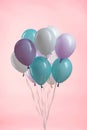 White, blue and purple party festive balloons on pink background. Royalty Free Stock Photo