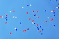 White, blue and red baloons flying high in clear blue sky Royalty Free Stock Photo