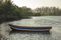 A white blue red empty wooden boat on the water at the shore Royalty Free Stock Photo