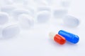 White, blue and red medicine antibiotic pills Royalty Free Stock Photo