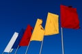 White, blue, red and orange flags fly against the sky Royalty Free Stock Photo