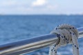 White rope on railing of boat Royalty Free Stock Photo