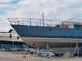 White blue sailboat beached for antifouling hull paint