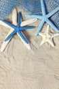 White and blue sea stars on sand Royalty Free Stock Photo