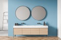 White and blue shower room with round mirrors