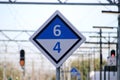 White and blue sign marking where to stop with 4 or 6 cars on train on the station platform on the Leiden Centraal station