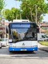 White blue Skoda trolleybus is based on Solaris vehicle on a city street on a sunny summer day. Modern city public electric