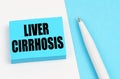 On a white and blue surface, a pen and blue stickers with the inscription - Liver cirrhosis
