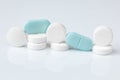 White and blue tablets or pills, medication or drugs. Closeup. Selective focus. Pharmacy, medicine, medical treatment concept Royalty Free Stock Photo