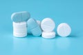 White and blue tablets or pills, medication or drugs. Closeup. Selective focus. Pharmacy, medicine, medical treatment concept Royalty Free Stock Photo