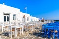 White and blue tavern tables on square in Naoussa port, Paros island, Greece Royalty Free Stock Photo