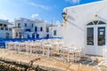 White and blue tavern tables on square in Naoussa port, Paros island, Greece Royalty Free Stock Photo