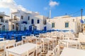 White and blue tavern tables on square in Naoussa port, Paros island, Greece Royalty Free Stock Photo
