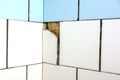 White and blue tiles on the wall. Old and broken tiles require replacement. Abstract background Royalty Free Stock Photo