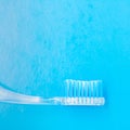 White blue toothbrush on a blue background, close-up medical abstract background Royalty Free Stock Photo