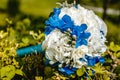 White blue unusual Bridal bouquet on a natural green background. Summer