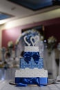 white and blue wedding cake three tiers