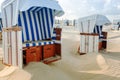 White and blue wicker beach chairs on the beach Royalty Free Stock Photo
