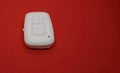 White bluetooth remote control camera shutter for smartphone, isolated on the red background. Royalty Free Stock Photo