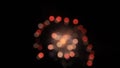 White, blueviolet, red and green circles of fireworks opening. Bokeh.