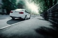 White BMW 3 Series F30 car is driving on asphalt road at summer daytime Royalty Free Stock Photo