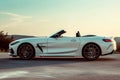 A White BMW Z4 Roadster Driving Down A Road, Showcasing Its Sleek Design And Powerful Performance, An Elegant, White Convertible