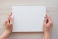 White board with hands for copy space. School office supplies on wooden background. Back to school concept. Top view Royalty Free Stock Photo