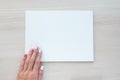 White board with hands for copy space. School office supplies on wooden background. Back to school concept. Top view Royalty Free Stock Photo