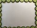 White board with sliced cucumber frame