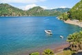 White boat anchored in sea bay surrounded by mountains Royalty Free Stock Photo