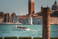 White boat floating in front of iconic clock tower in the heart of Venice Royalty Free Stock Photo